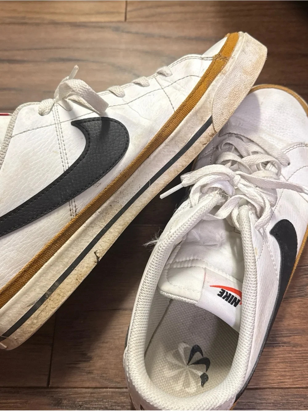 Nike White Low-Top Sneakers with Black Swoosh and Brown Trim
